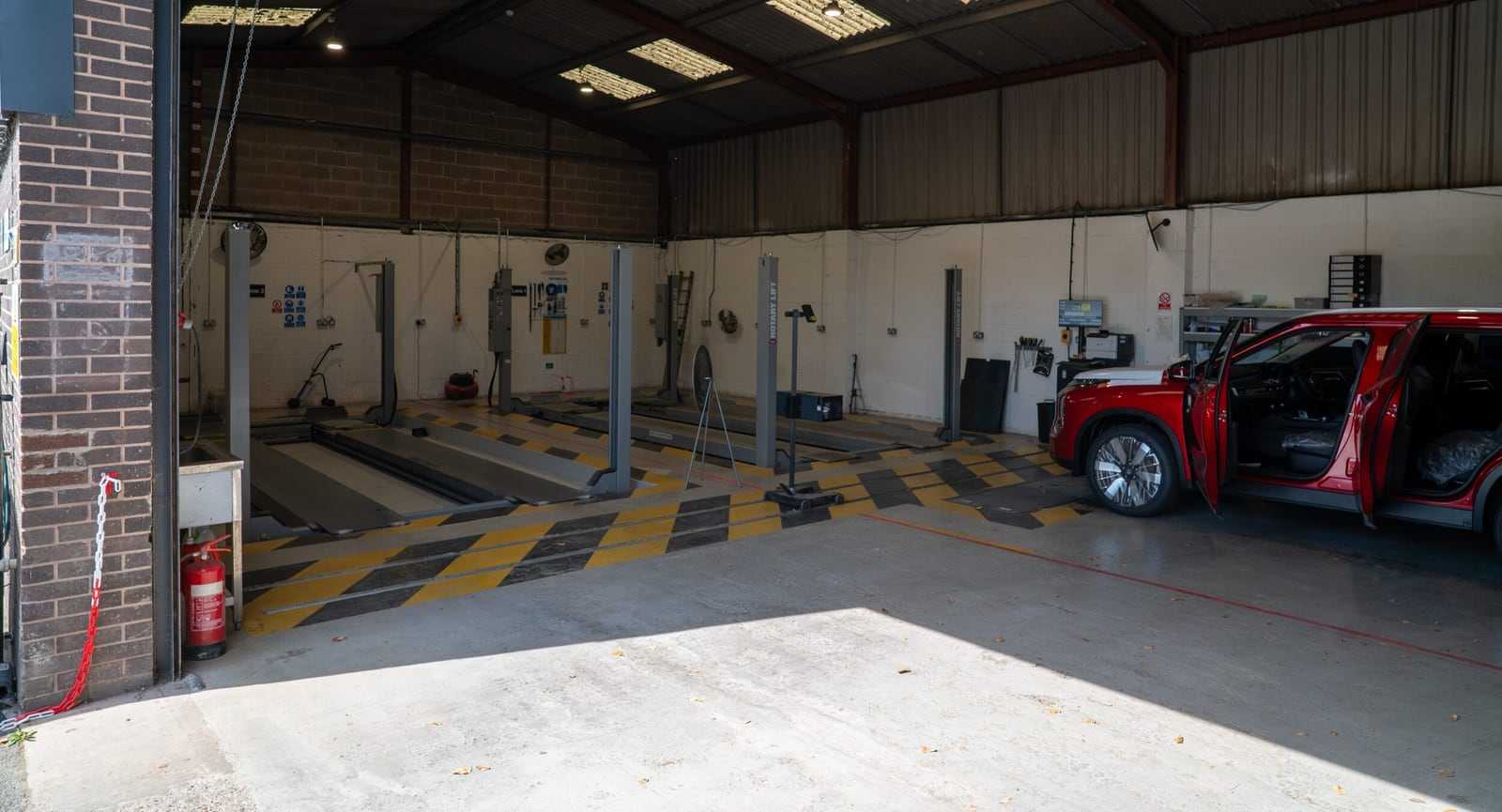 Inside our testing bay, looking down the inspection lane with a red SUV on the ramp