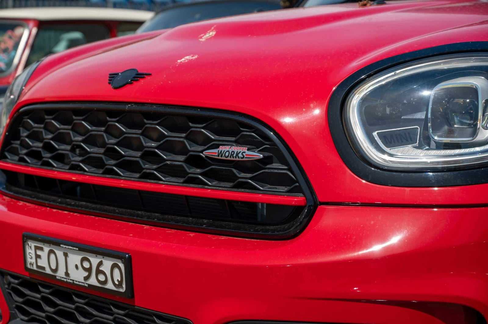 The grille and headlight of a red MINI John Cooper Works that arrived from Australia