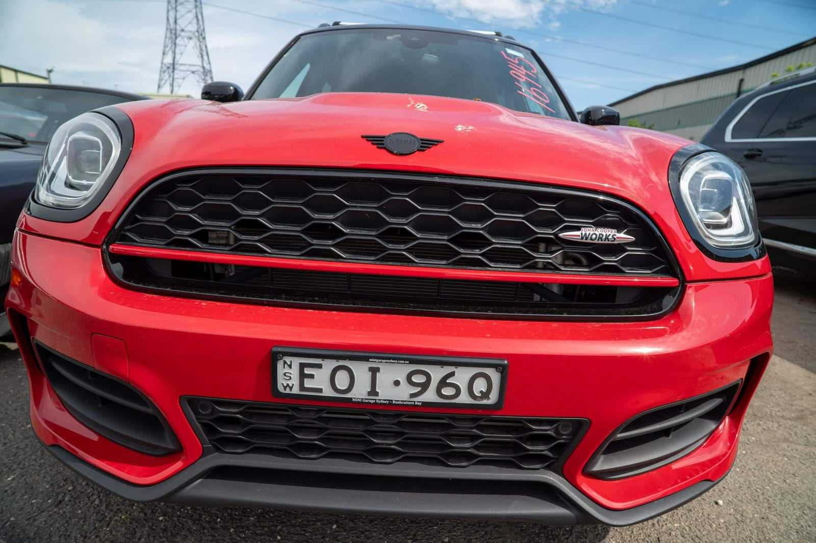 A red Mini John Cooper Works on New South Wales plates, in a Sydney dealer's plate surround