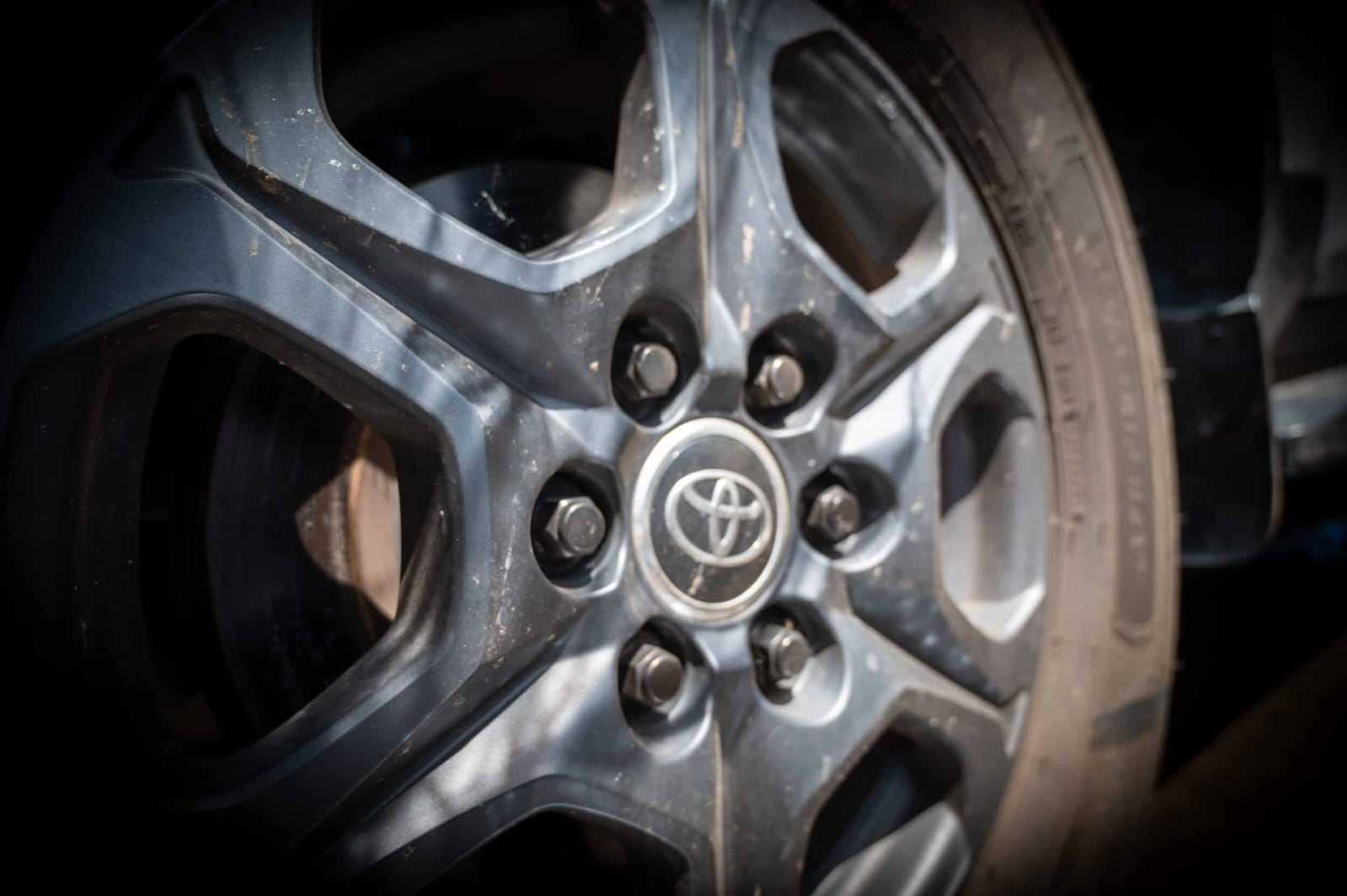 A Toyota wheel centre badge and well-used tyre on an Australian import