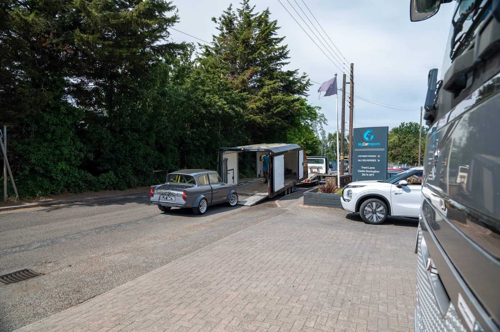 Our enclosed car transporter parked on the entrance drive, beside the My Car Import sign